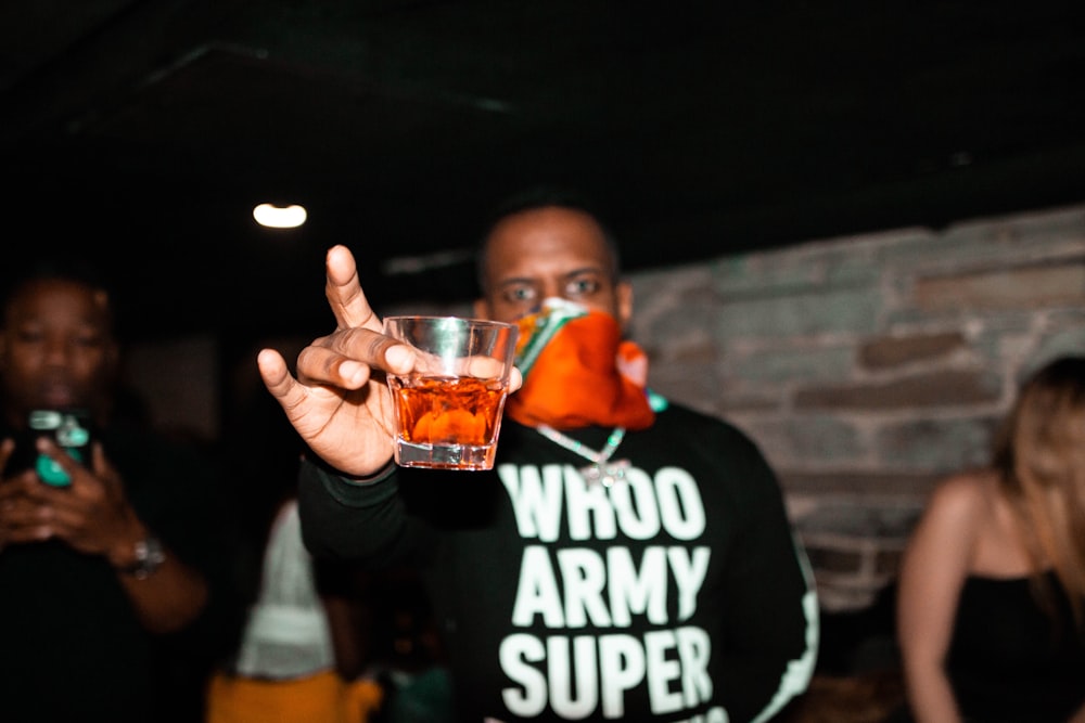 man holding rocks glass