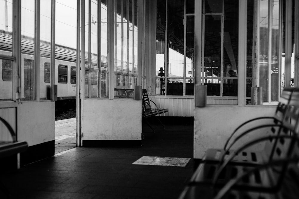 grayscale photo of chair near door