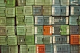 Industrial plastic crates stacked neatly in a warehouse environment.