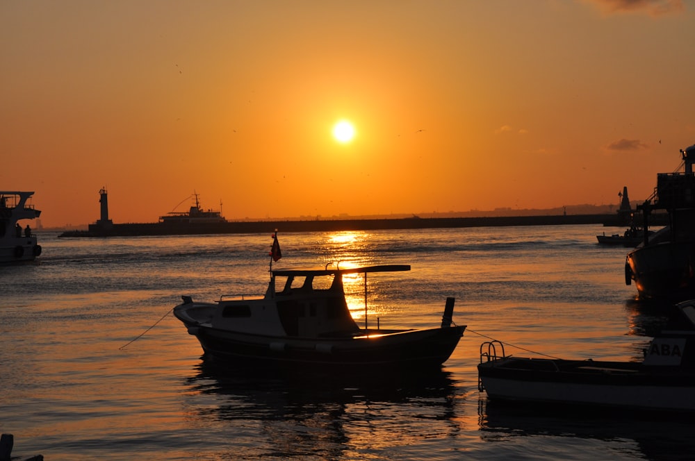 boat beside dock during sunset