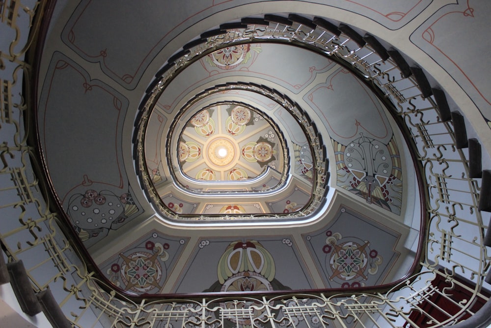 a spiral staircase in a building with intricate designs