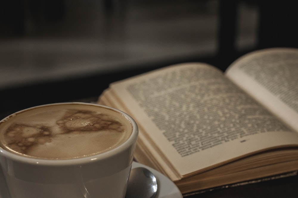 white ceramic cup and printed book pages