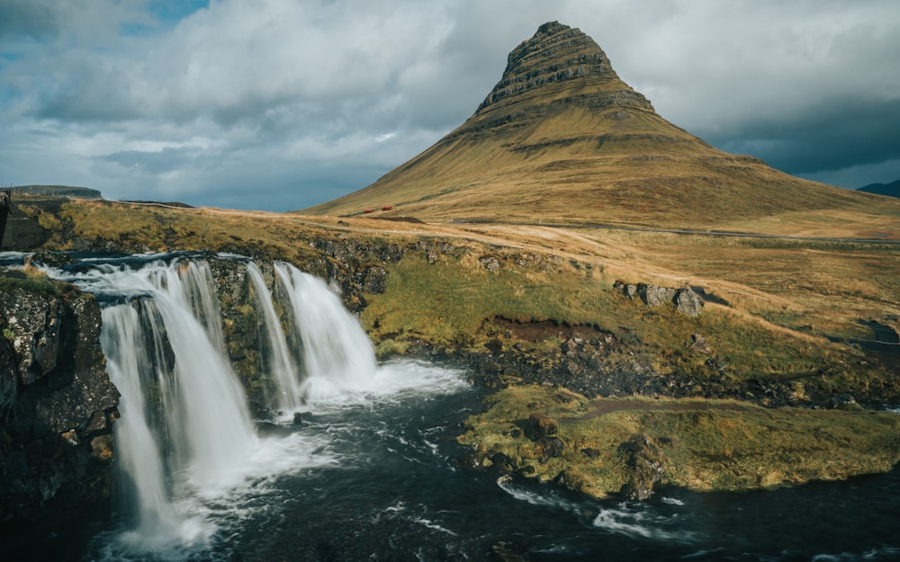 brown and green mountain and waterfall