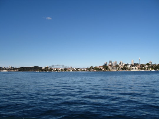 cityscape facing body of water under blue sky in Sydney Nowa Południowa Walia Australia