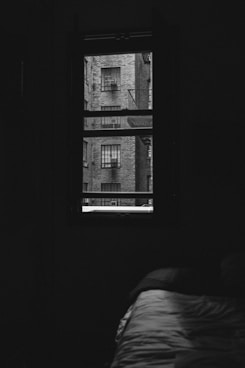 bed by glass window