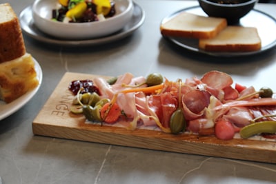 sliced vegetables on wooden chopping board ham zoom background