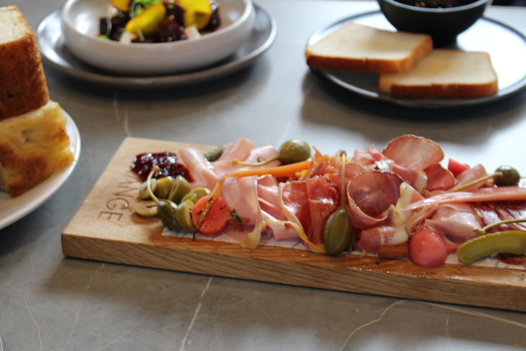 sliced vegetables on wooden chopping board, Antipasto meats and olive platter at The Grange