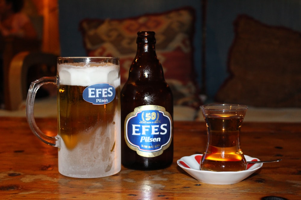 Efes beer bottle beside mug