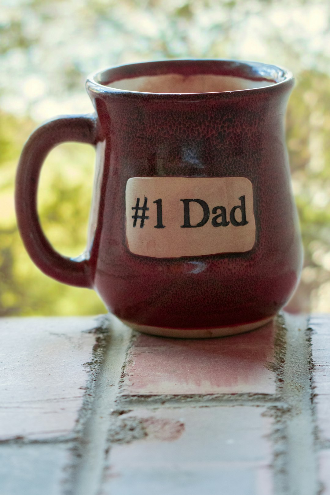 shallow focus photo of maroon ceramic mug