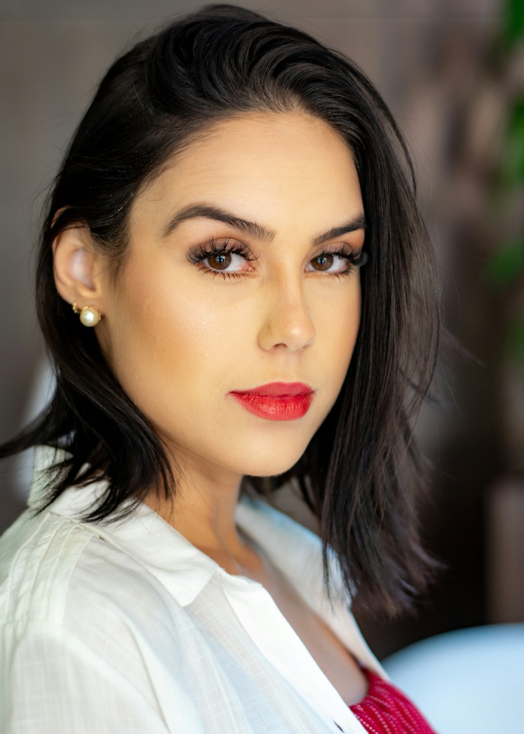 woman in white top with red lipstick