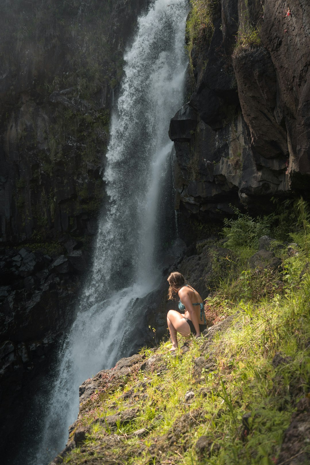 woman sitting on cliff