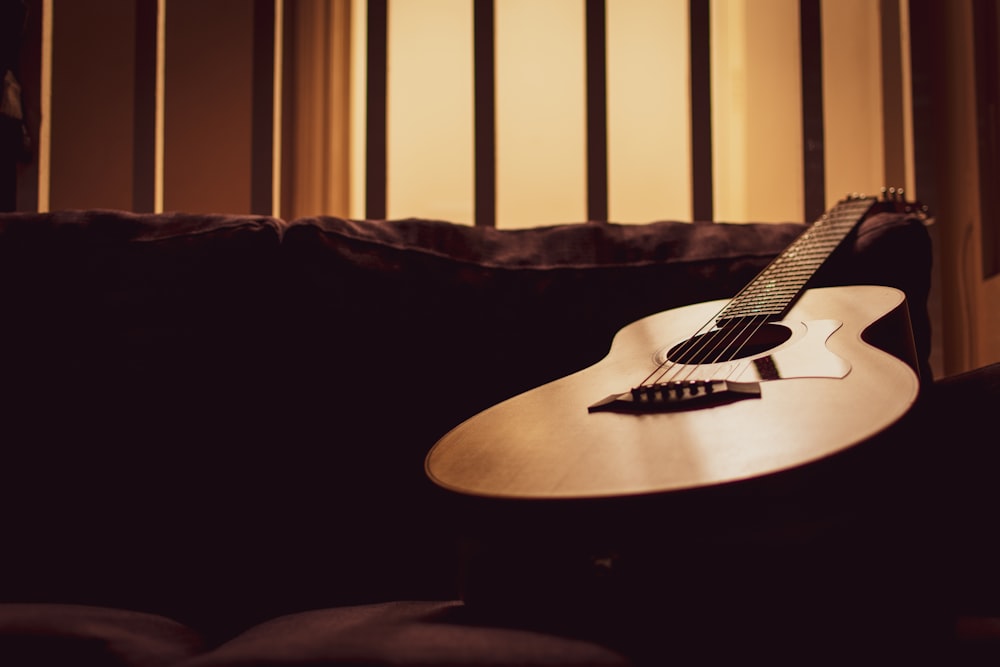 acoustic guitar on sofa