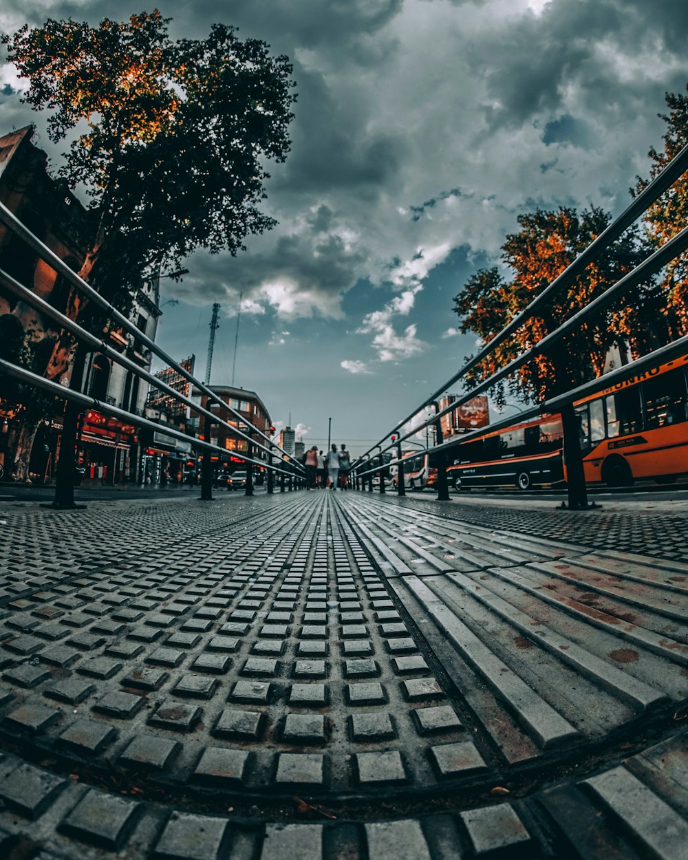 people standing on bridge