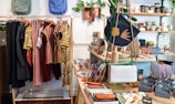 assorted-colored clothes on rack near brown wooden table