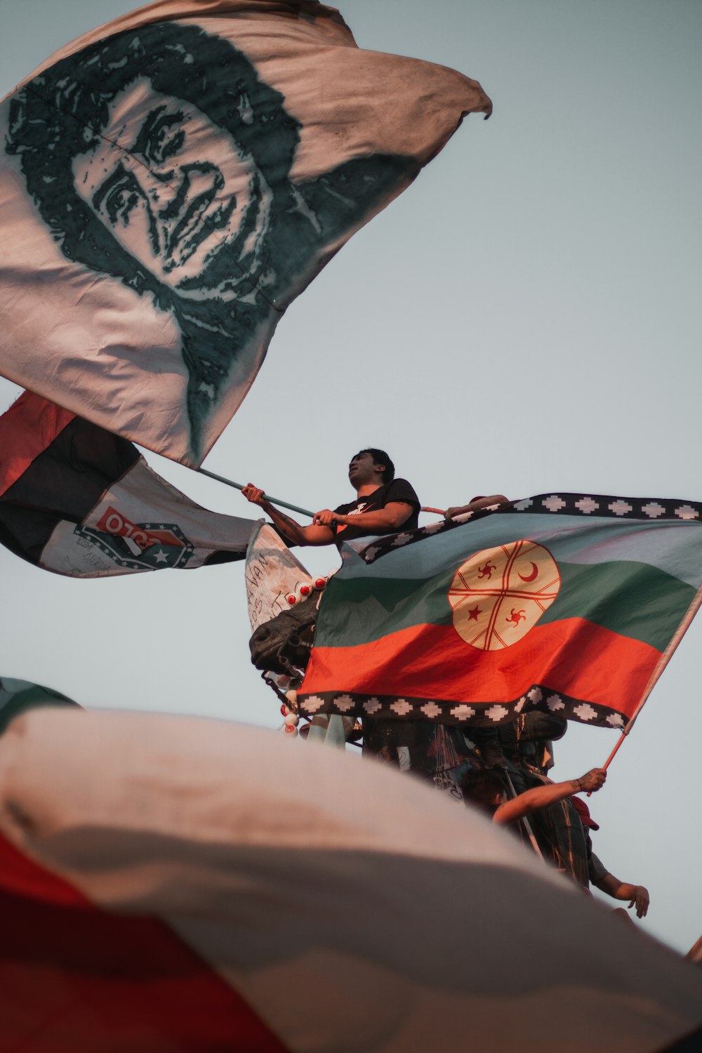 people waving flags during day