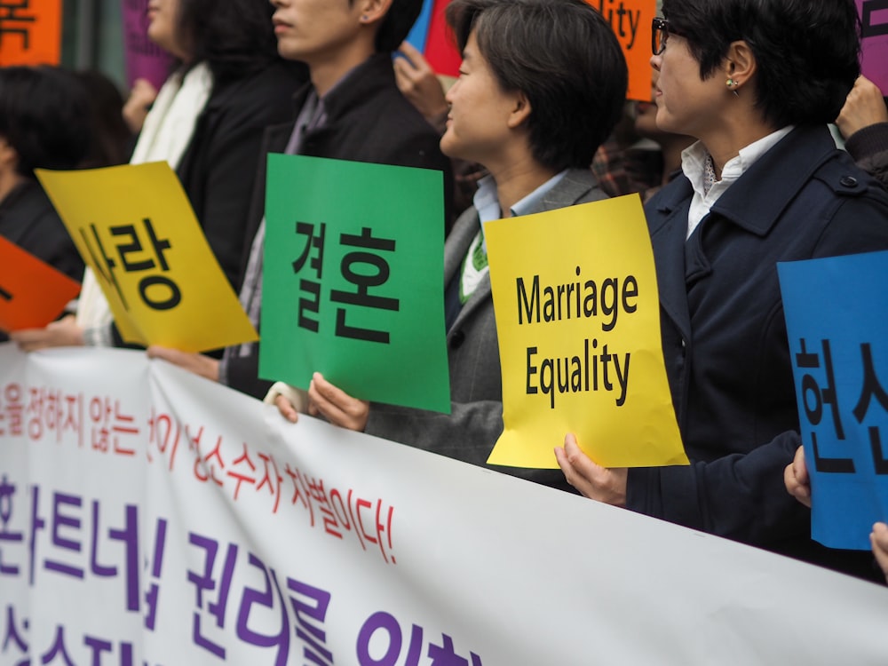 people holding Hangul banners