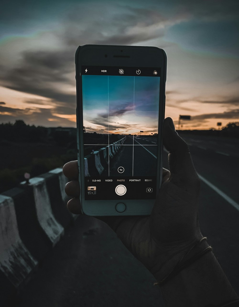 gold iPhone 6 capturing road barricade during dawn