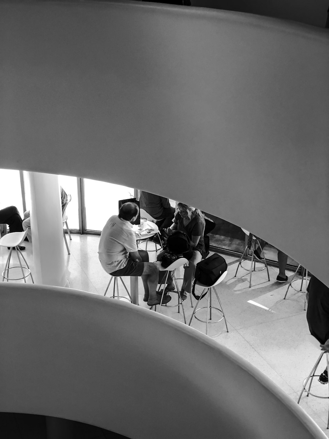 people inside building with tables and chairs