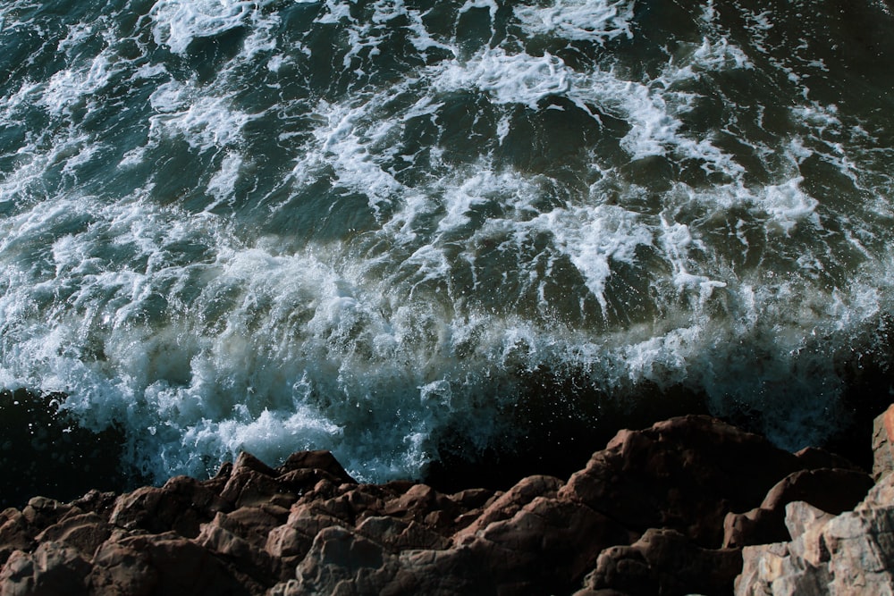 aerial photography of cliff and body of water