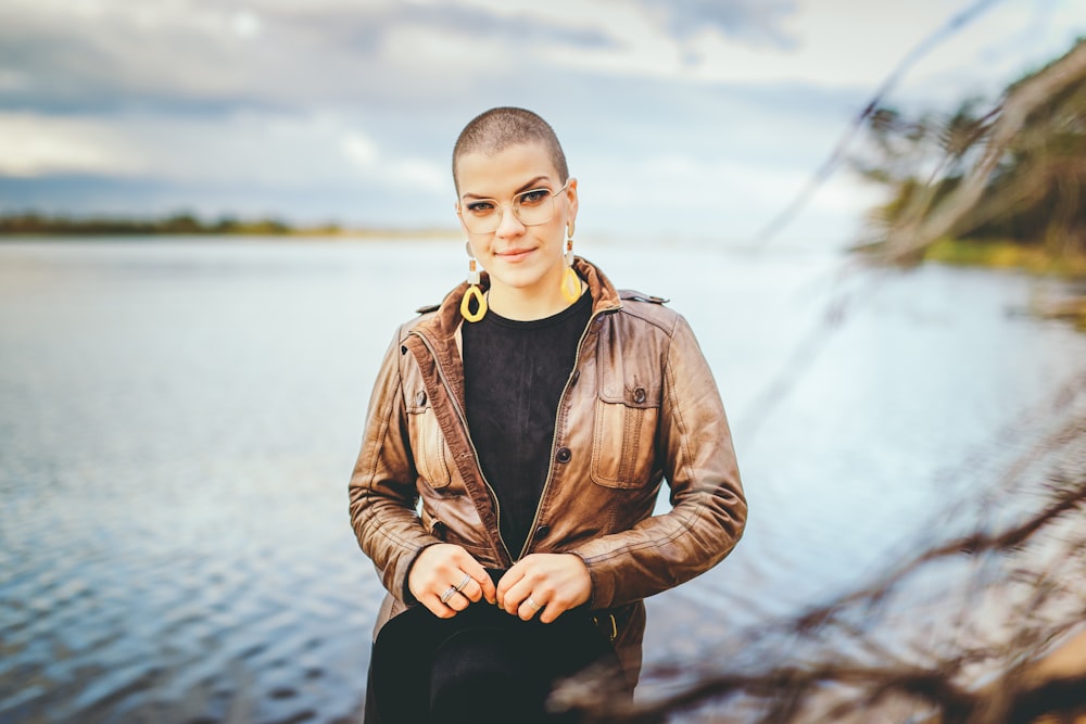 woman sitting near lake