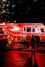 person standing near lighted firetruck