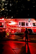 person standing near lighted firetruck