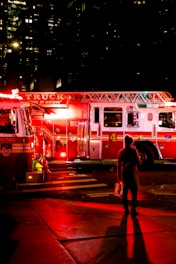 person standing near lighted firetruck