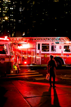 person standing near lighted firetruck