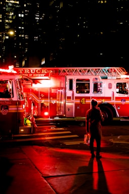 person standing near lighted firetruck