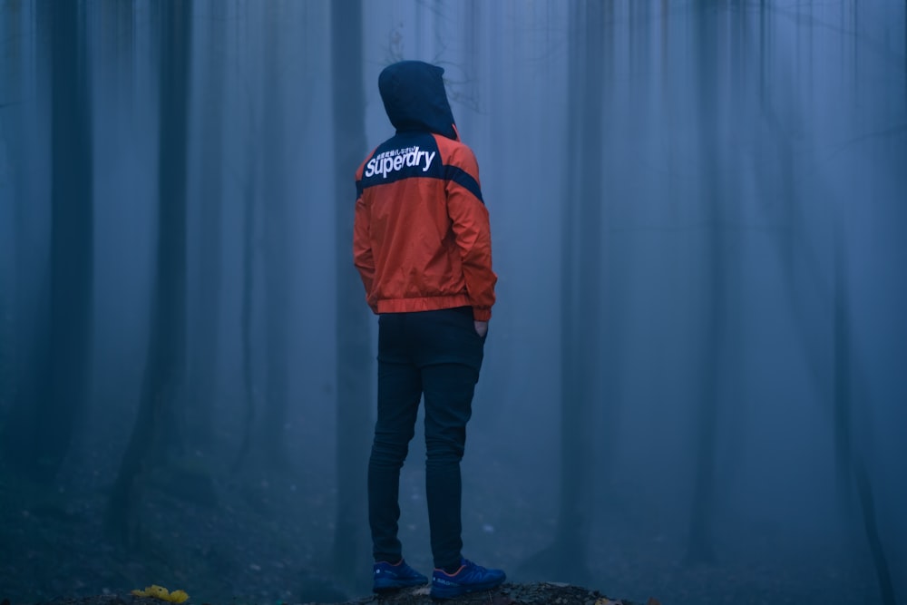 man standing near trees