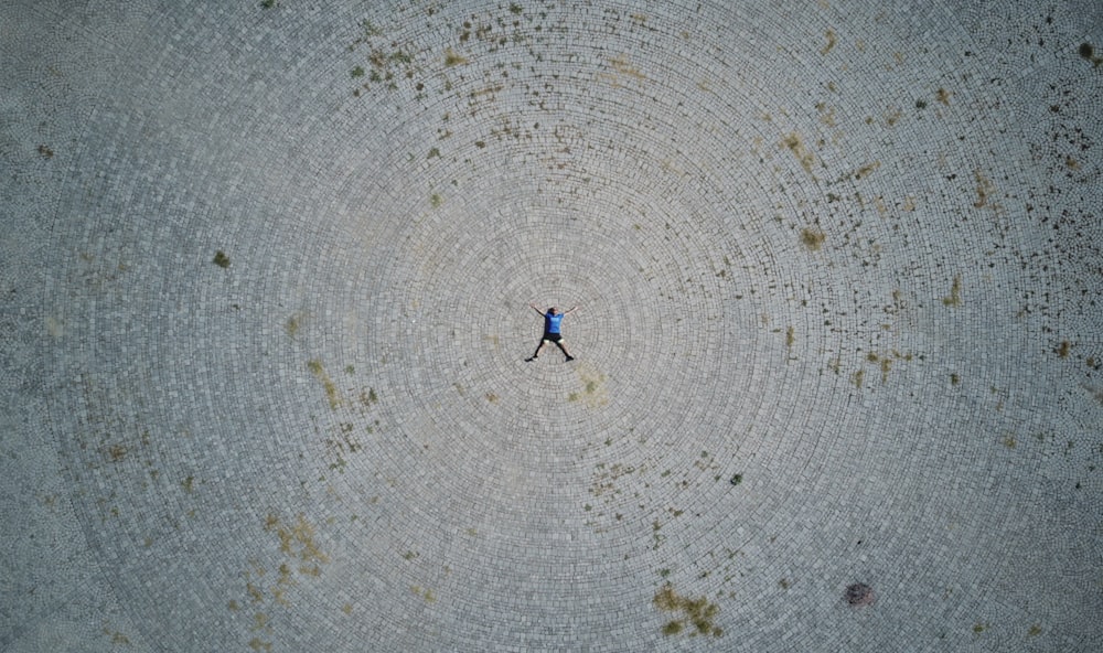 person lying forward on gray field