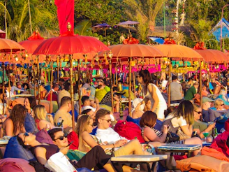 Colorful party tents and lounge areas arranged on a sunny beach, ready for a lively celebration.