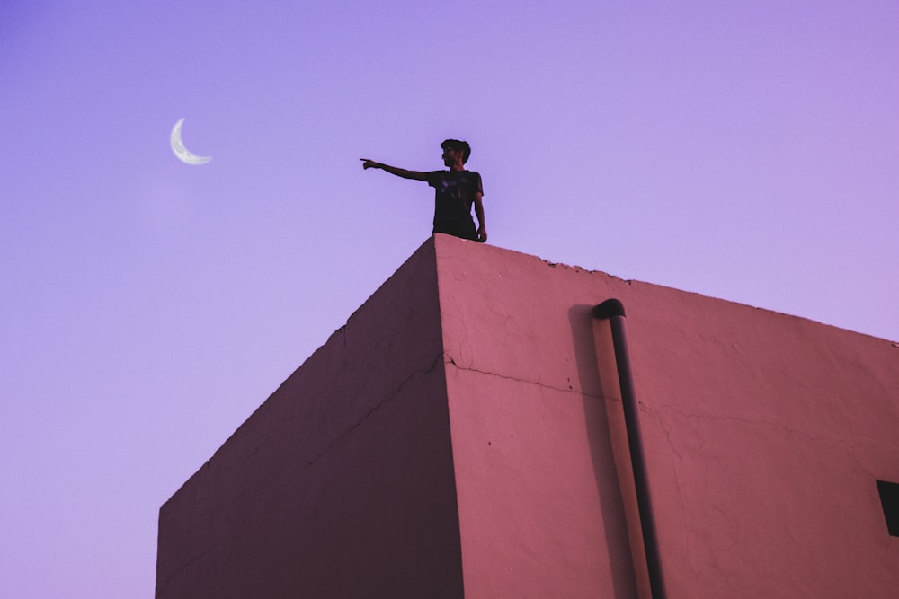 man standing on building top