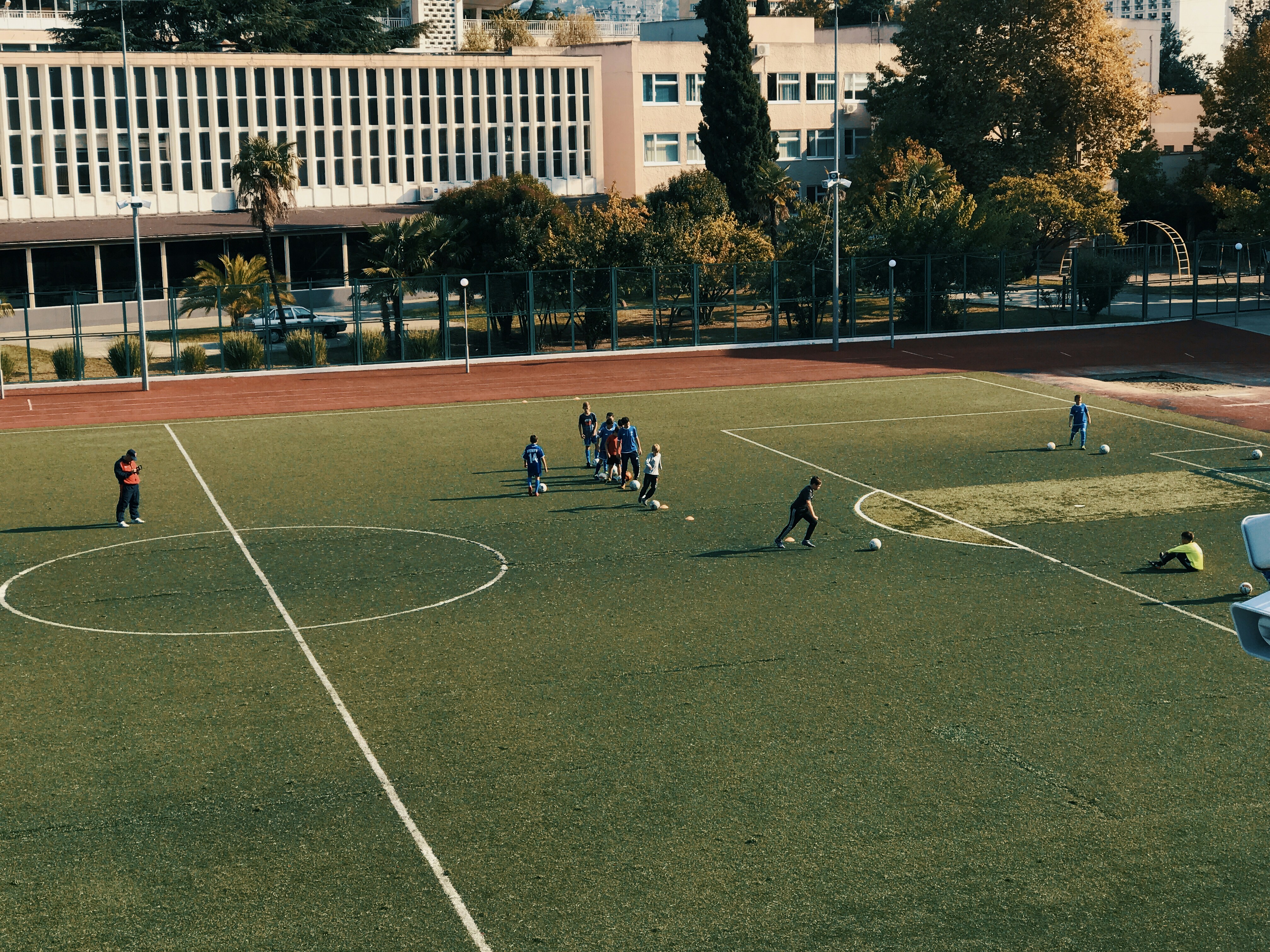people playing soccer on open field