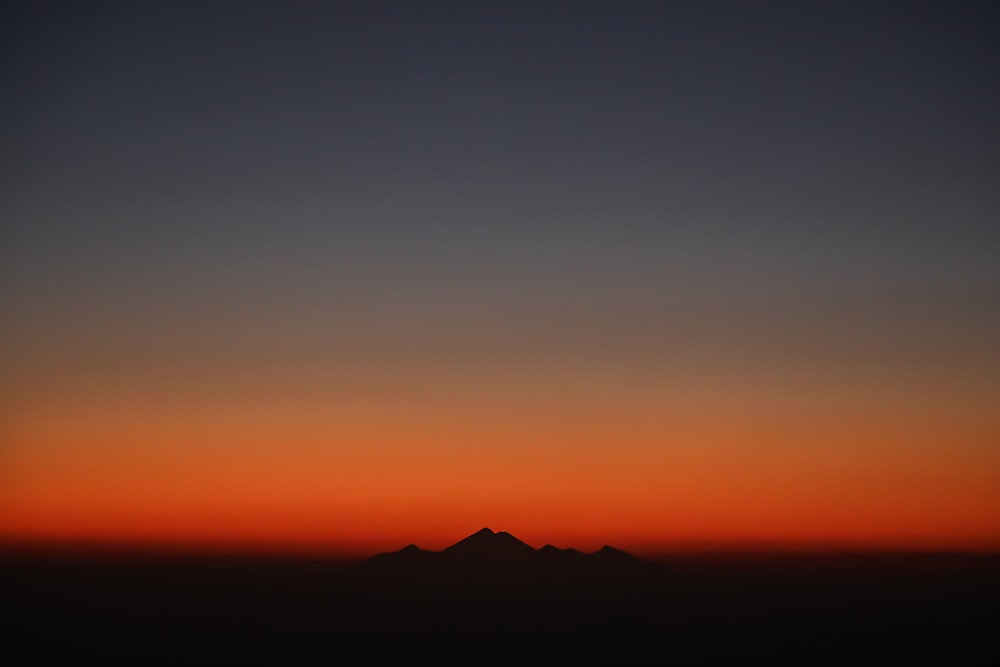 silhouette of mountain during golden hour