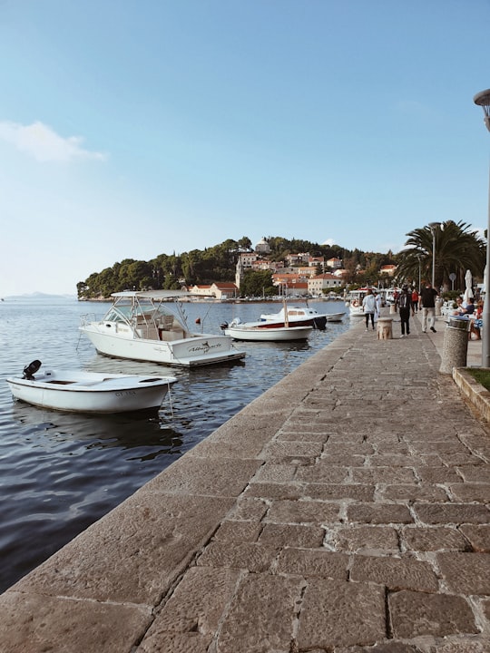 people walking beside boats in Harbor Croatia