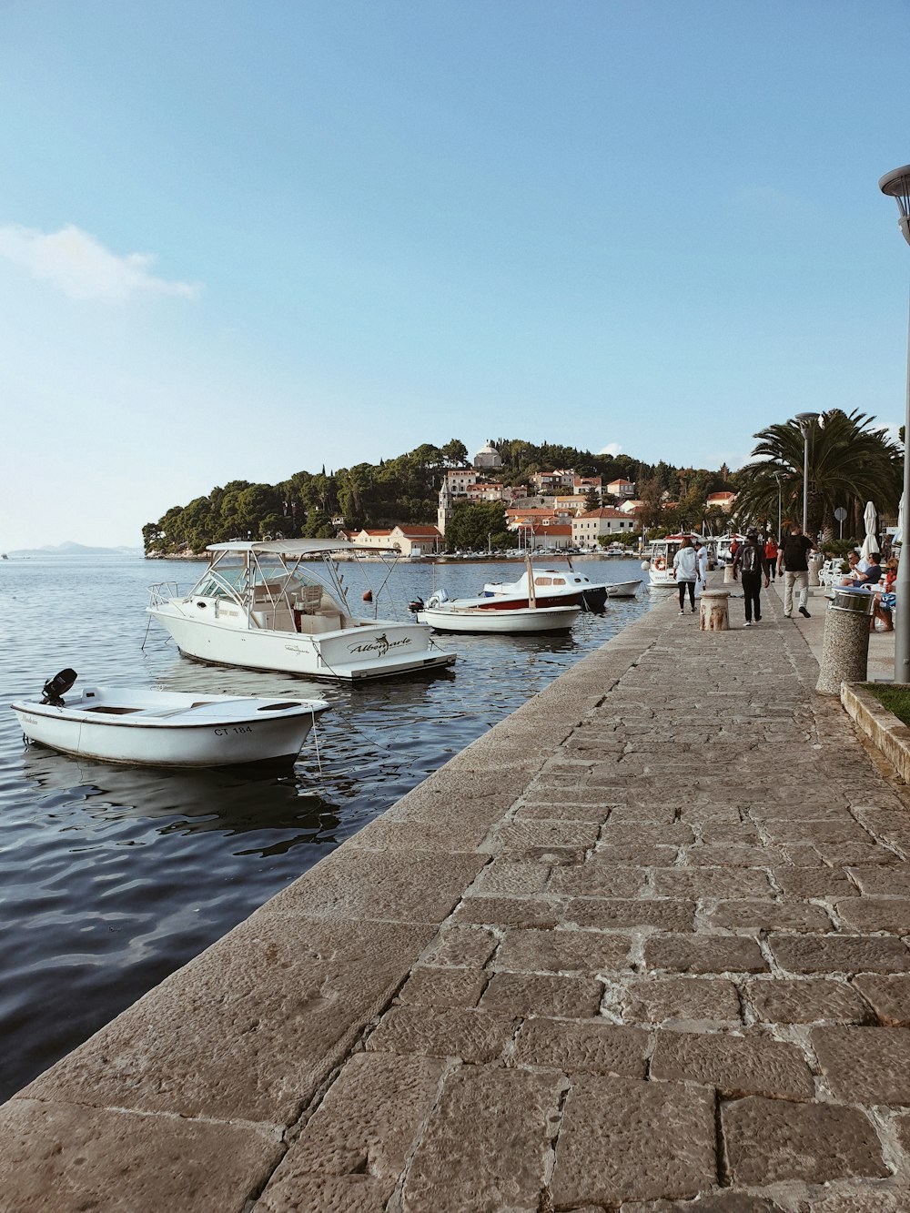 people walking beside boats