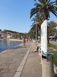 View of Barranquilla's Malecon del Rio with people enjoying the waterfront on a sunny day.