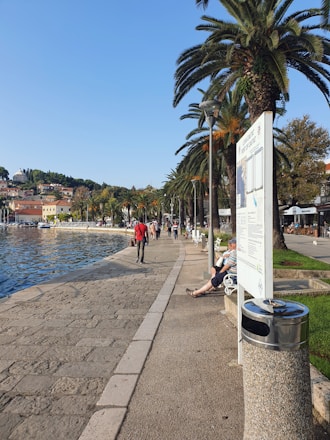 View of Barranquilla's Malecon del Rio with people enjoying the waterfront on a sunny day.