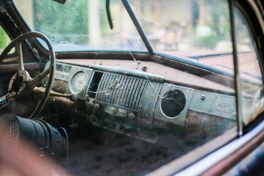 the interior of an old car with a broken windshield