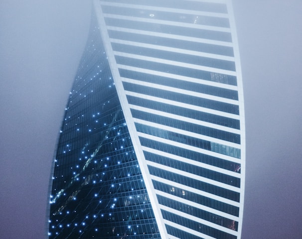 a very tall building in the middle of a foggy sky