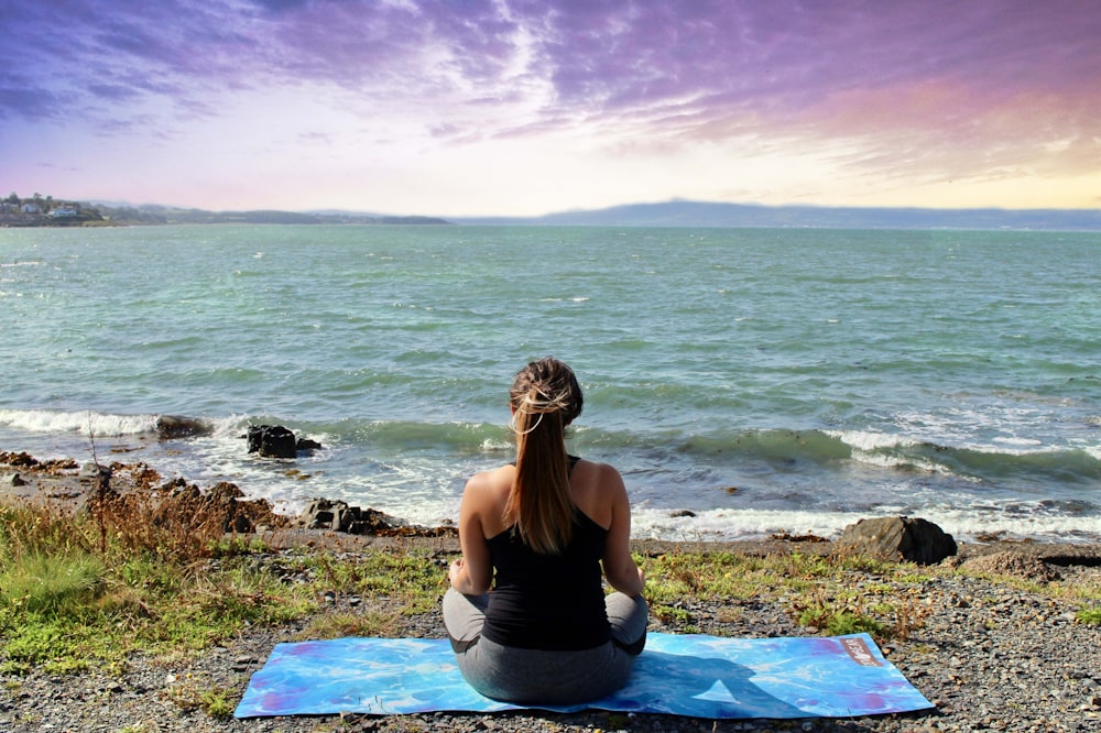 woman meditating at beach