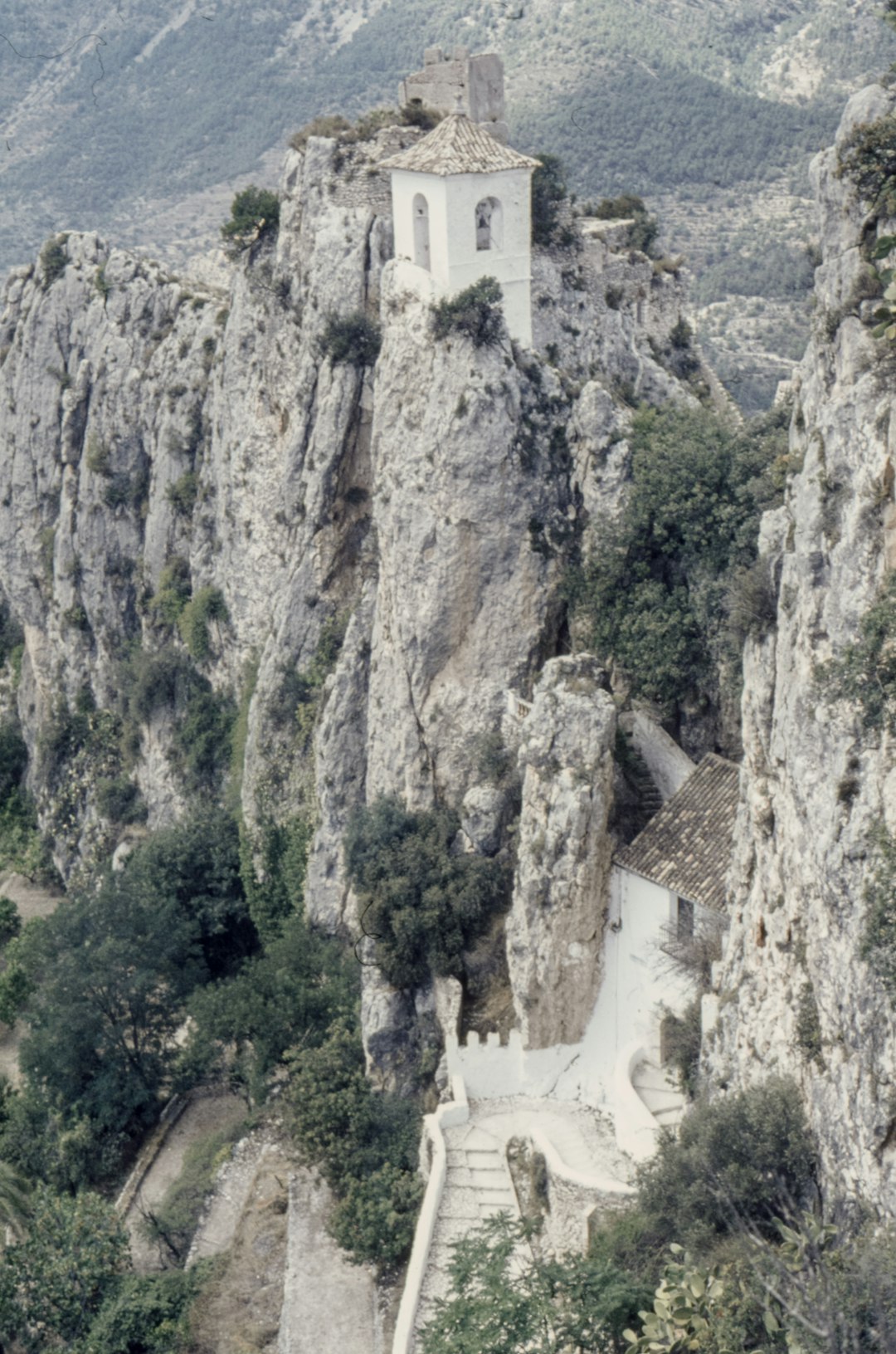 white concrete building on cliff during daytime