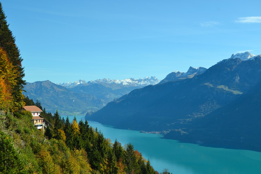 body of water beside mountain during daytime