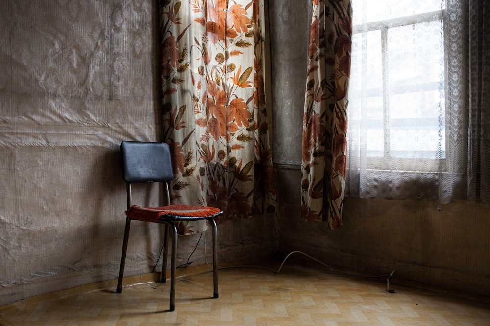 chair near window with curtain