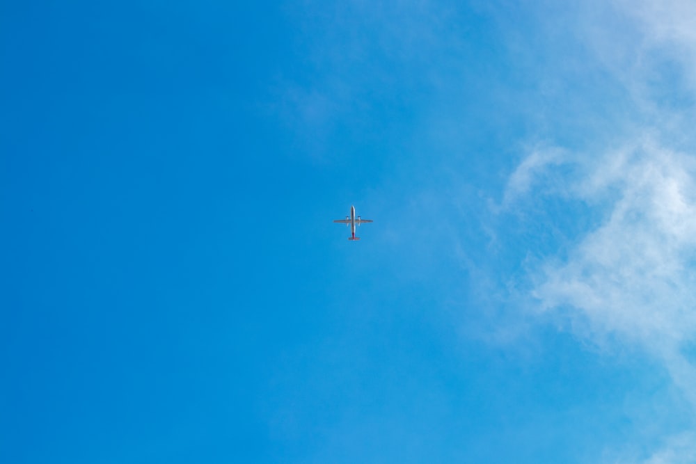 low-angle photography of gray airplane on air