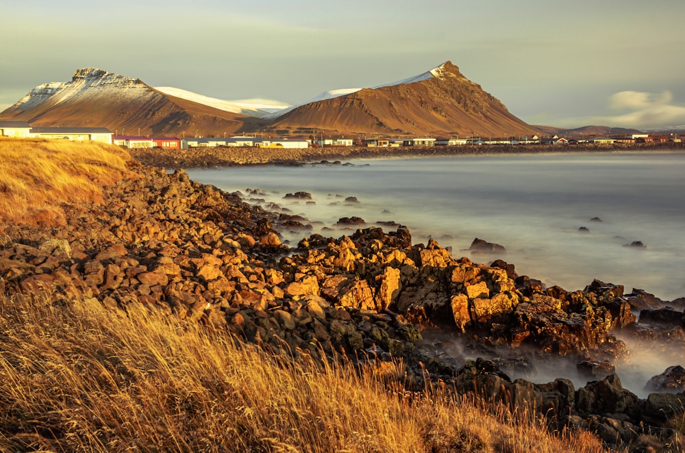 rocky island with buildings during day