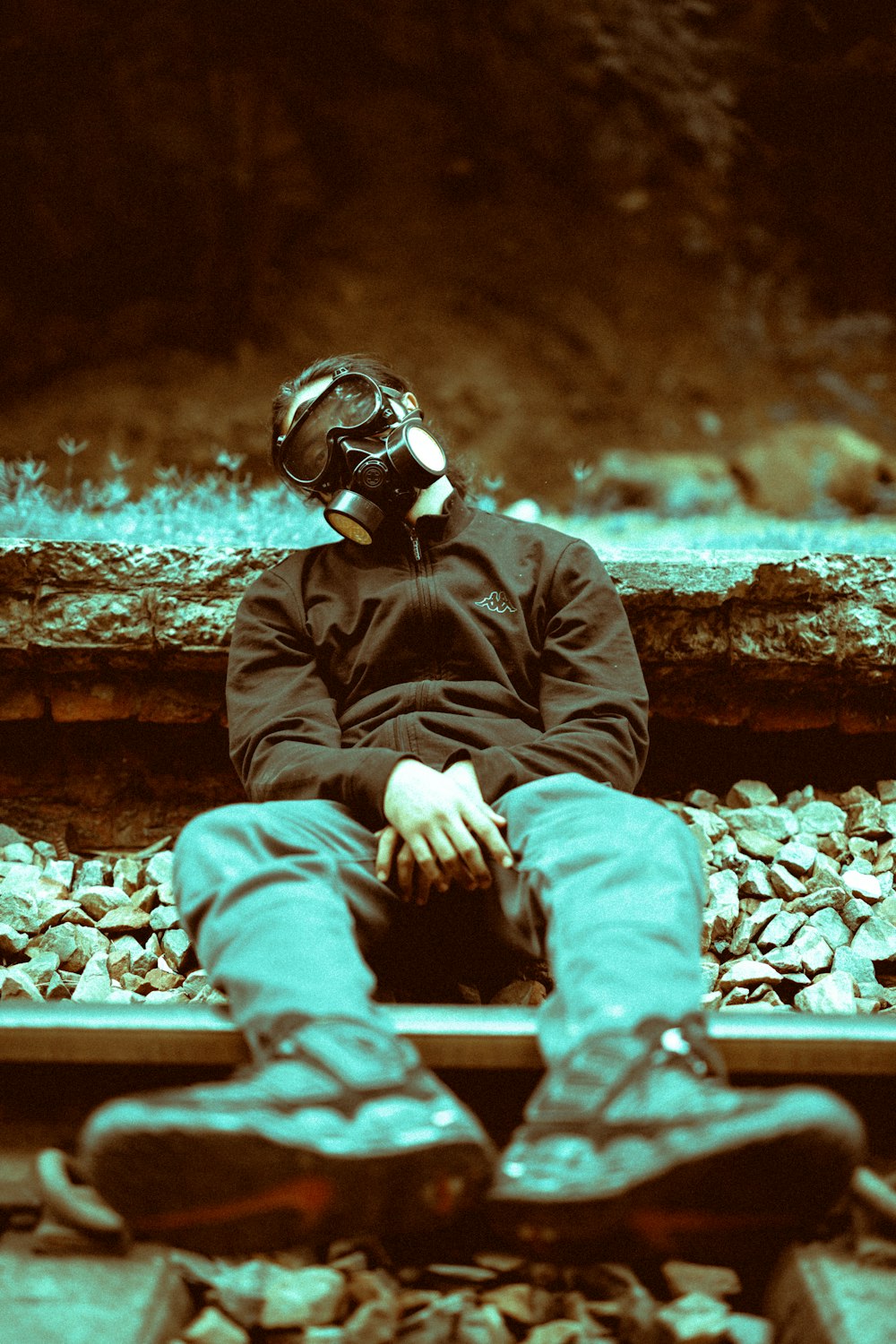 person lying on train rails