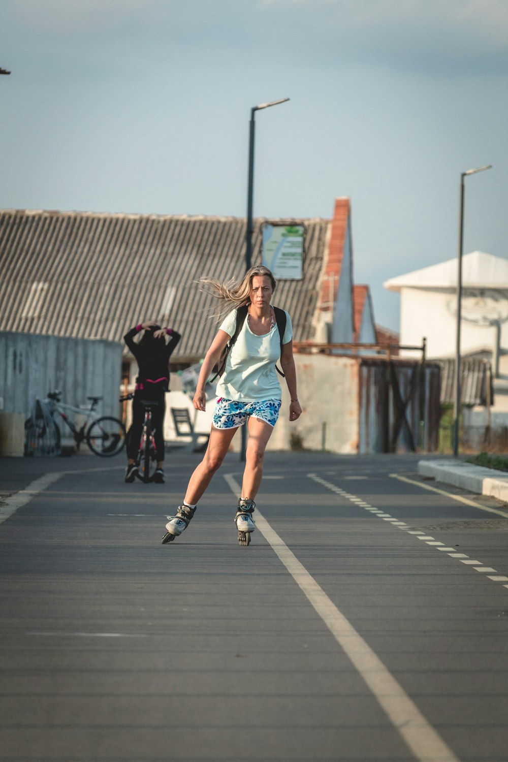 woman riding roller blades on road during daytime