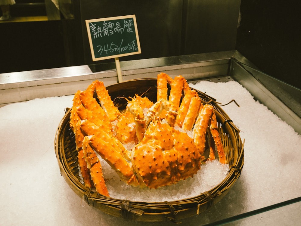 big crab in brown wicker basket with ice on display